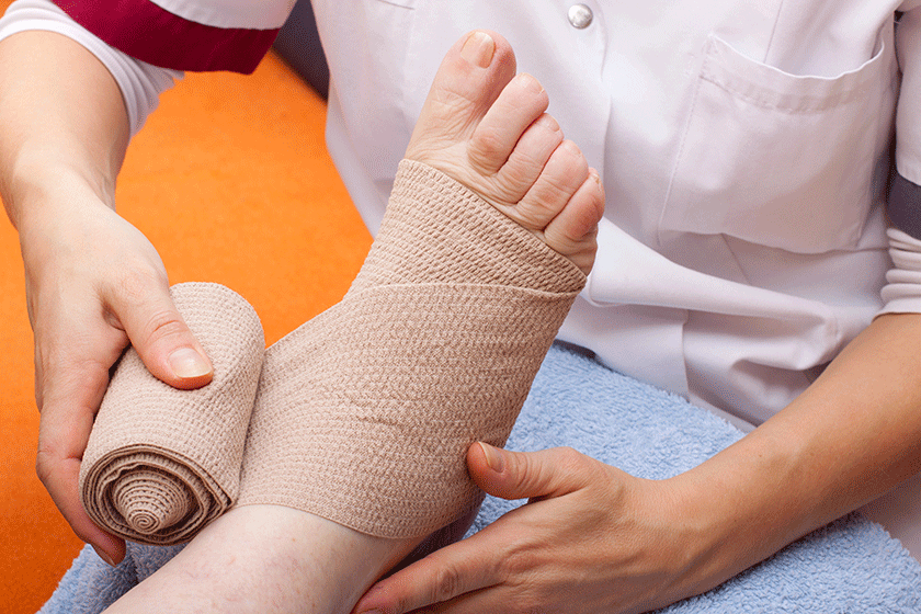 Doctor bandaged foot of a patient