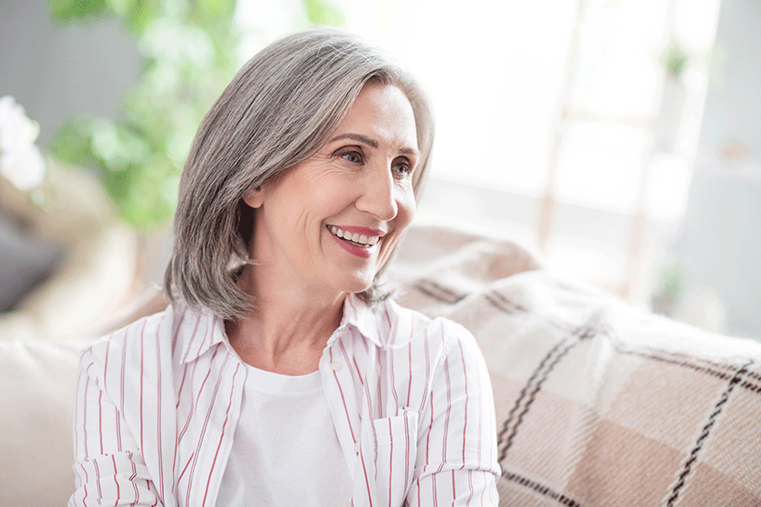 Photo of dreamy happy positive old woman smile