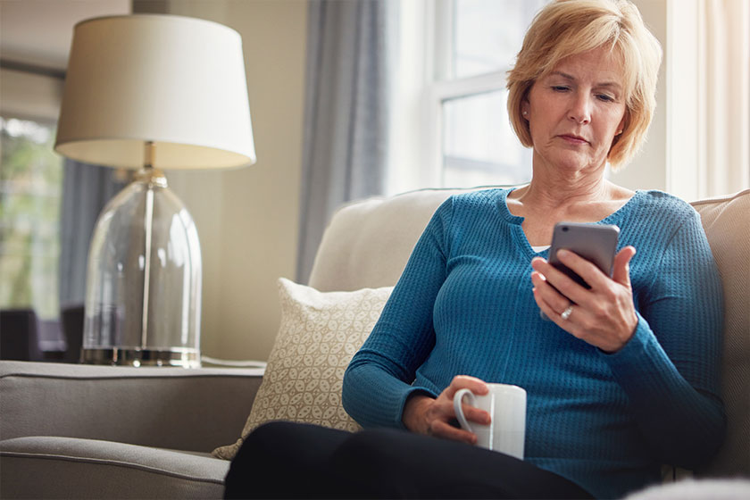 Home, relax and old woman on sofa with cellphone typing connection