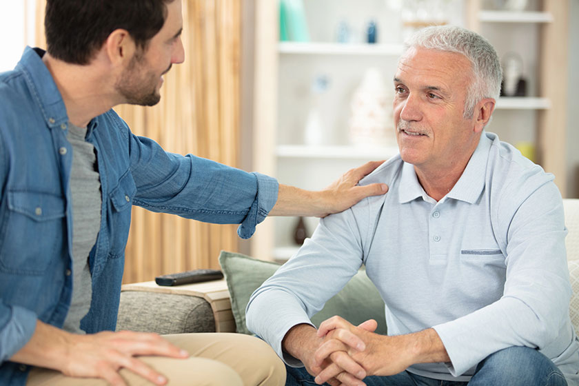 Man with his hand on male friends shoulder